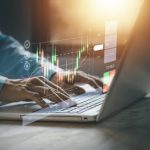 Stock chart or cryptocurrency chart with businessman hand typing notebook (Laptop). Statistics graph and char growing graph. Success business concept.